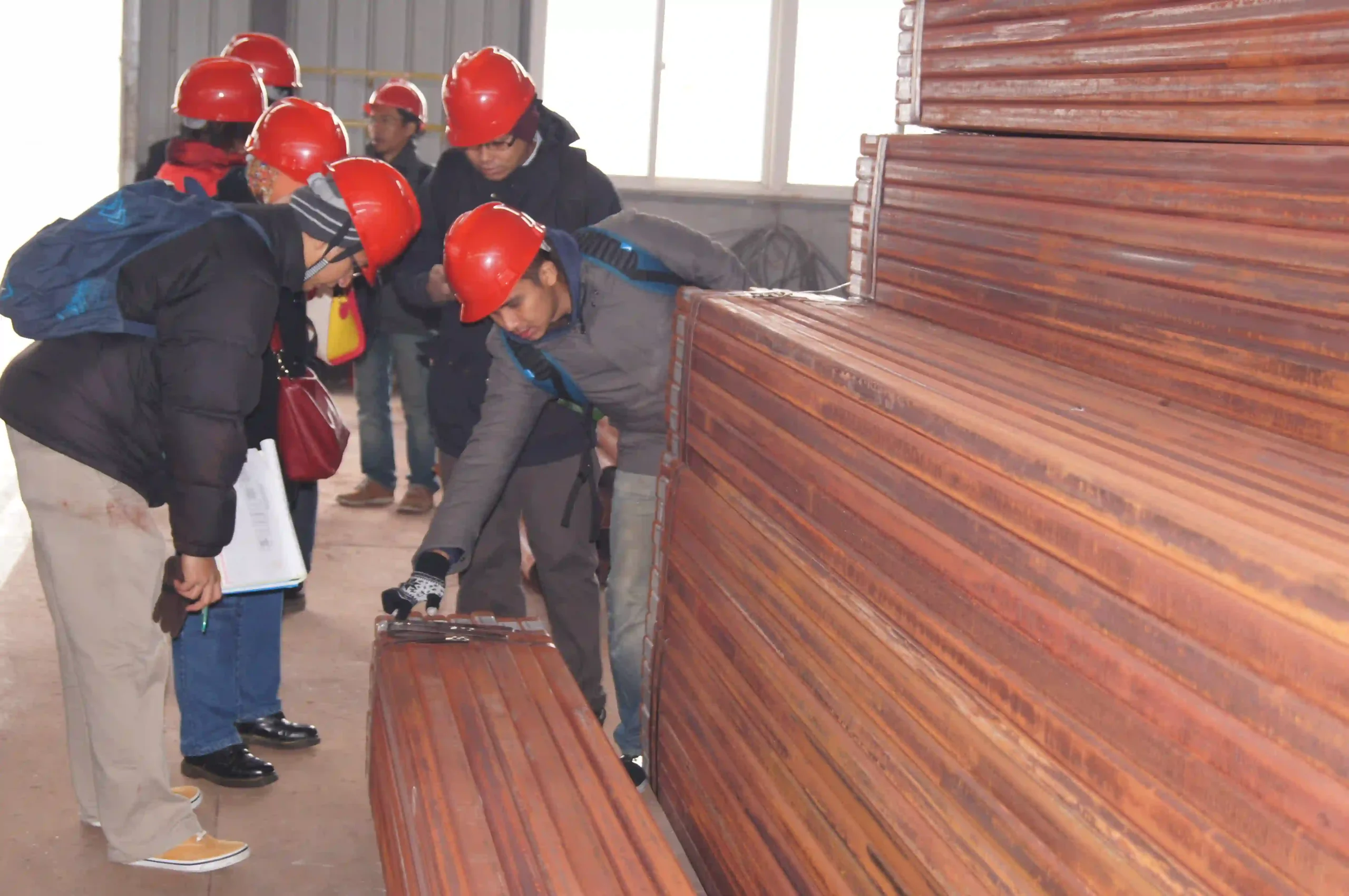 Client performing pre-shipment inspection of fabricated steel components