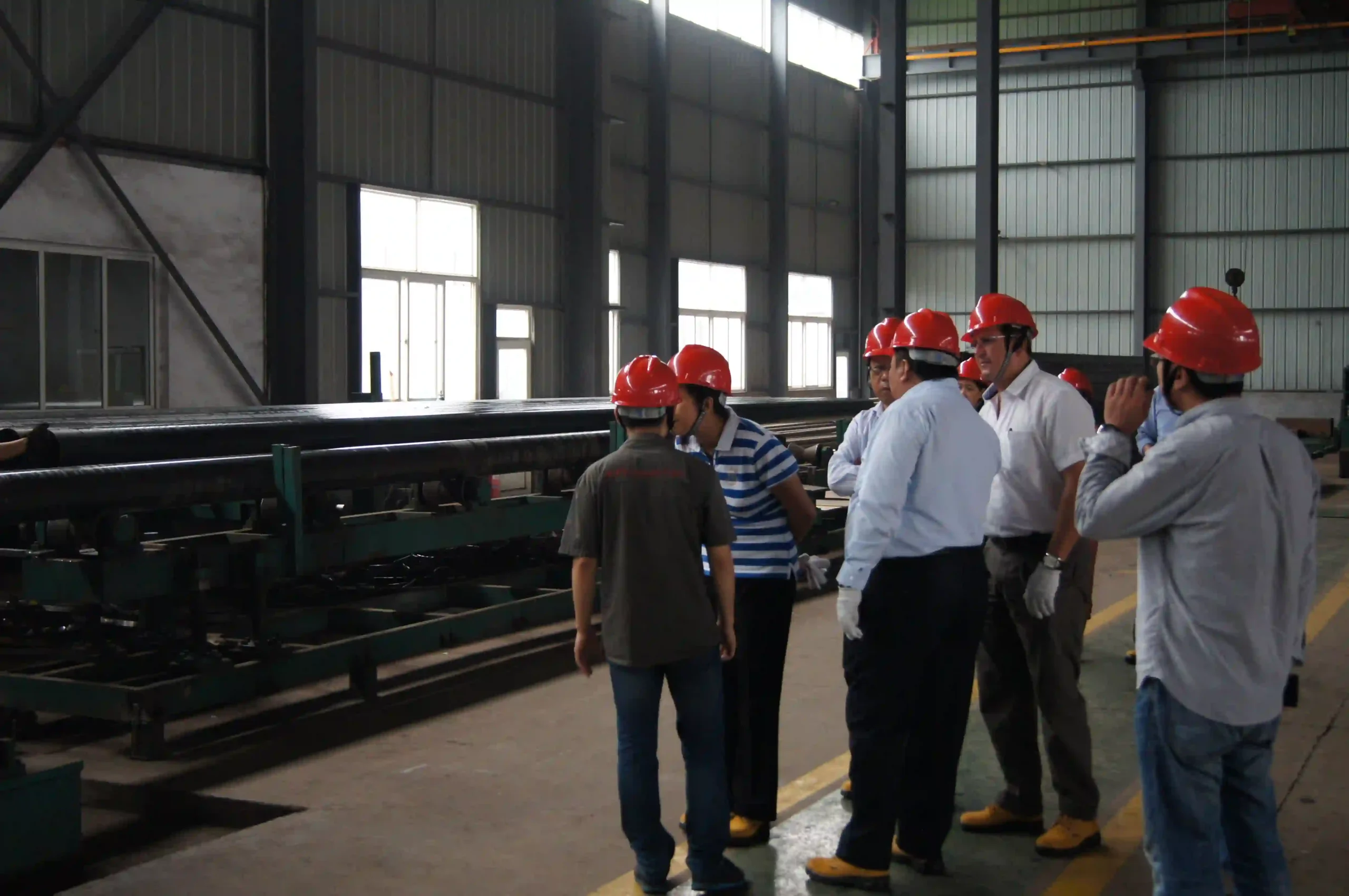 Client team discussing fabrication details with engineers in the workshop