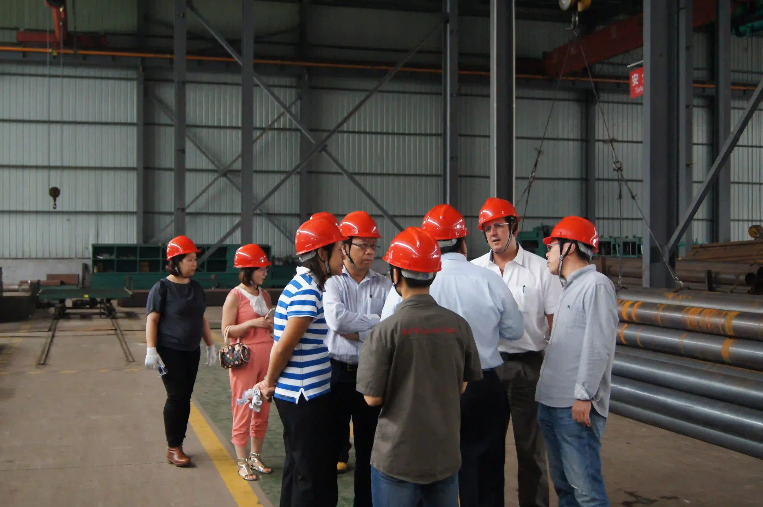 International buyer reviewing steel production line during factory visit