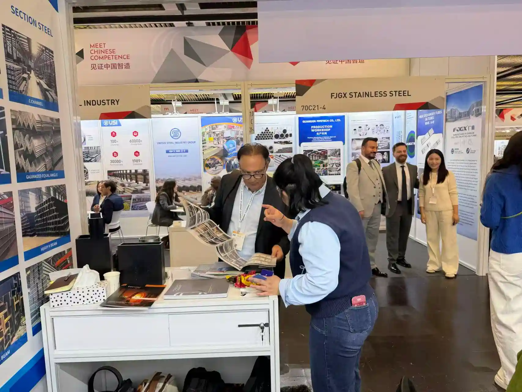 Team members welcoming buyers at an international exhibition booth